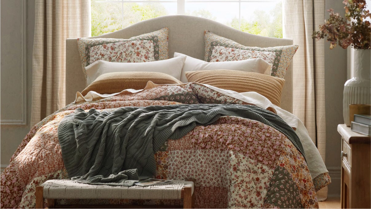 image of bed with floral pattern quilt